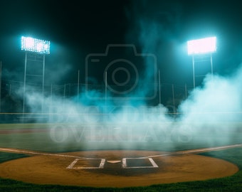 May include: A baseball field at night with two bright lights illuminating the field. The field is covered in a thick fog. The lights are on tall poles and are casting a blue glow on the fog.