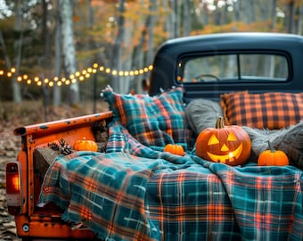 May include: A vintage pickup truck bed decorated for Halloween with a plaid blanket, pillows, and a jack-o'-lantern.  The truck is parked in a wooded area with fall foliage and string lights.
