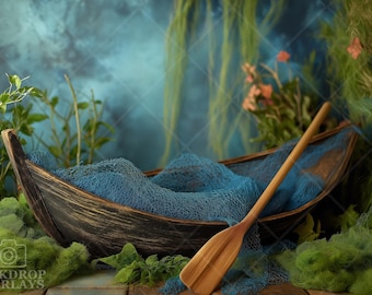 May include: A wooden boat with a blue fabric lining and a wooden oar resting inside. The boat is surrounded by green foliage and a blue and green background.