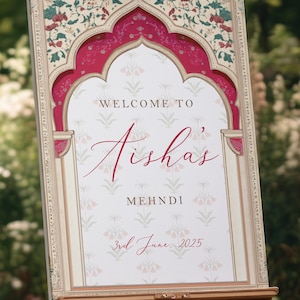 Peut inclure: Panneau d&eacute;coratif sur chevalet avec un motif floral et l'inscription "Welcome to Aisha's Mehndi" en &eacute;criture &eacute;l&eacute;gante. Le panneau est encadr&eacute; d'une bordure rouge et cr&egrave;me, et la date "3rd June, 2025" est affich&eacute;e en bas.