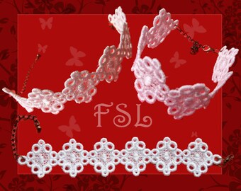 May include: Two delicate white lace bracelets with intricate floral designs. The bracelets are made of white lace and have a delicate, feminine look.