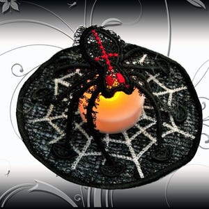 May include: Black and white spiderweb design with a red spider and a small candle in the center. The design is made of black lace and is perfect for Halloween decor.