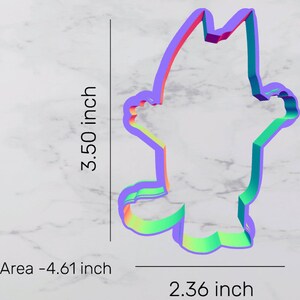 May include: A rainbow-colored cookie cutter shaped like a cartoon cat. The cutter is 3.50 inches tall and 2.36 inches wide. Area -4.61 inch.