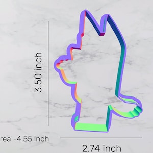 May include: A colorful cookie cutter shaped like a cartoon character. The cutter is 3.50 inches tall and 2.74 inches wide. The area of the cutter is 4.55 square inches.