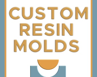 May include: A square graphic design featuring the text CUSTOM RESIN MOLDS in gold, sans-serif capital letters. Below the text, a gold semi-circle sits above a blue U-shaped form, all enclosed within a thin gold border on a white background.