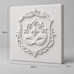 May include: A square white wall plaque featuring a raised relief design of a masquerade mask centered within an ornate shield frame topped with fleur-de-lis motifs. The plaque measures 30 cm in height, 30 cm in width, and 2 cm in depth.