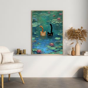 May include: A framed art print showing two cats in a pond with lily pads and flowers. One cat is ginger and white, the other is black. The artwork has a painterly style with a blue and green colour palette.