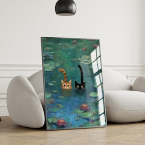 May include: A framed art print depicting two cats in a pond with water lilies. One cat is ginger, the other is black. The artwork is displayed in a modern living room, leaning against a white sofa, creating a stylish interior.