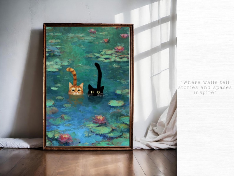 May include: A framed art print shows two cats in a pond with lily pads and flowers. One cat is ginger and white, the other is black. The water is blue and green. The text on the right says, "Where walls tell stories and spaces inspire."