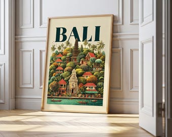 May include: A framed art print featuring a colorful illustration of Bali. The artwork depicts a lush landscape with temples, houses, and palm trees, with the word "BALI" in large, dark green letters at the top.