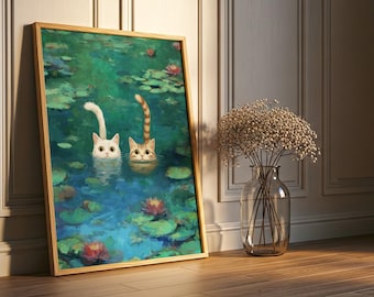 May include: A framed art print depicts two cats in a pond with lily pads and flowers. One cat is white, the other is tabby. The artwork is in a wooden frame and leans against a wall. A vase of dried flowers sits nearby.