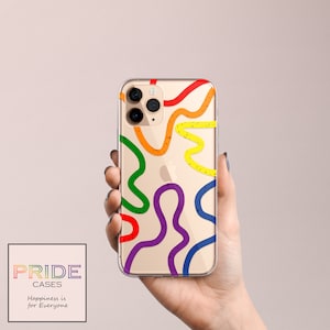 May include: A clear phone case with a rainbow design. The case has a gold background with colourful lines and glitter. The case is designed to fit an iPhone 11 Pro.