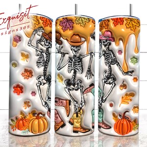 May include: Three white tumblers with a fall-themed design. Each tumbler features a skeleton wearing a cowboy hat and boots, surrounded by autumn leaves, pumpkins, and acorns. The tumblers are filled with a yellow liquid that appears to be dripping down the sides.
