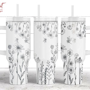May include: Three white stainless steel tumblers with black floral designs and lids. The tumblers have handles and straws.