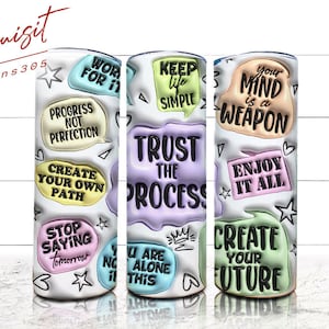May include: Three white tumblers with colorful motivational quotes. The quotes are: "Work for it", "Keep life simple", and "Your mind is a weapon".