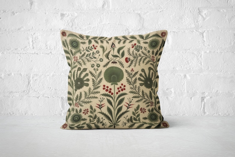 May include: A decorative throw pillow with a beige background and a green and red floral pattern. The pattern features stylized flowers, leaves, and berries.
