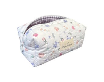 May include: White quilted makeup bag with a floral print and the text "So Much Punchierss" on the front.