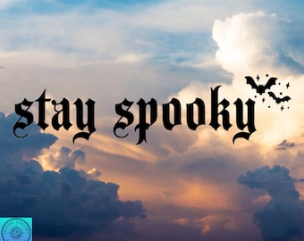 May include: A graphic design with the text "stay spooky" in a gothic font against a backdrop of a cloudy sky with a sunset.