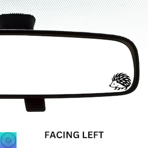 May include: Black and white silhouette of a hedgehog facing left, in the reflection of a rearview mirror. The text "FACING LEFT" is printed below the mirror.