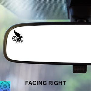 May include: A black rearview mirror with a black winged monkey sticker on the glass. The text "FACING RIGHT" is printed below the mirror.