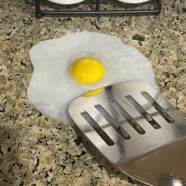 Fried egg sunny side up cooking rest cute realistic egg perfect spoon spatula rest