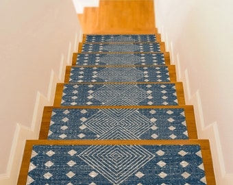 May include: A set of blue and white patterned stair treads with a geometric design. The treads are made of a soft, durable material and are perfect for adding a touch of style to any staircase.