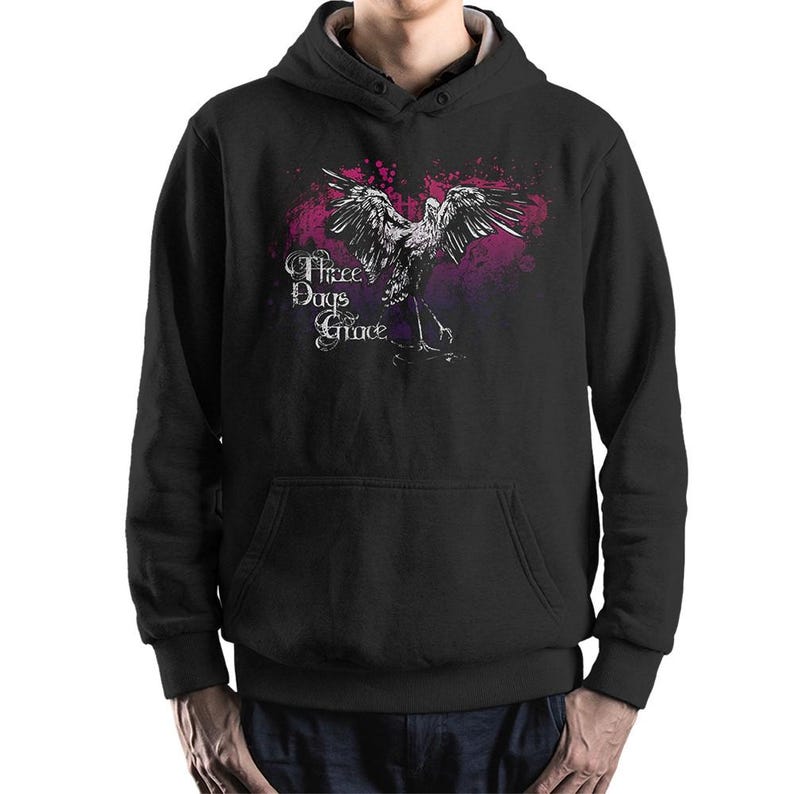 May include: Black hooded sweatshirt featuring a graphic of a bird with outstretched wings, set against a pink and purple splatter design. The text "Three Days Grace" is printed in a stylized font above the bird.