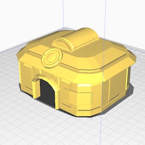 May include: A yellow 3D printed model of a building with a rounded roof and a circular design on the front. The building has a door and windows.