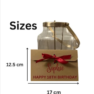 May include: A brown envelope with a red ribbon and the text "Sophie Happy 18th Birthday". The envelope is 12.5 inches tall and 17 inches wide.