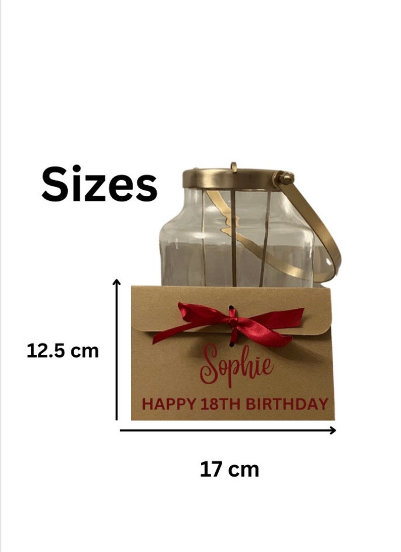 May include: A brown envelope with a red ribbon and the text "Sophie Happy 18th Birthday". The envelope is 12.5 inches tall and 17 inches wide.