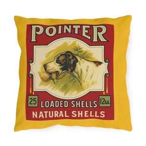 May include: Yellow square throw pillow with a vintage-style design. The design features a Pointer dog with a bird in its mouth, set against a red and cream background. Text includes "POINTER", "25 LOADED SHELLS", "12 GA.", and "NATURAL SHELLS".