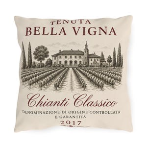May include: A square throw pillow with a cream-colored background featuring a dark red and black illustration of a vineyard and estate. The text reads TENUTA BELLA VIGNA, Chianti Classico, DENOMINAZIONE DI ORIGINE CONTROLLATA E GARANTITA, and 2017.
