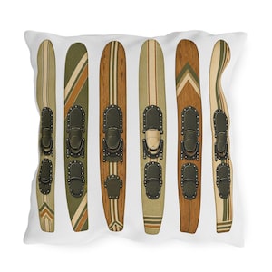 May include: A cushion with a vintage design of six water skis. The skis have various wood grain patterns, stripes, and metal bindings. The colour palette includes shades of brown, green, and cream, creating a retro aesthetic.