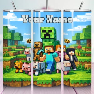 May include: A cylindrical metal tumbler with a straw featuring a Minecraft-themed graphic print of characters, animals, and blocky landscapes. The text Your Name is printed in white block letters at the top against a blue sky background.