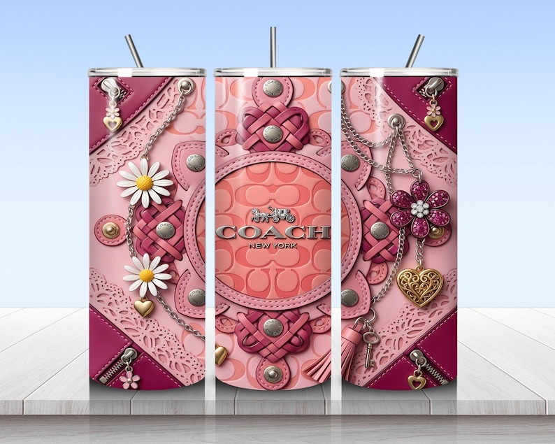 May include: A cylindrical tumbler with a straw featuring a pink and magenta leather-textured pattern with Coach New York branding. The design includes metallic chains, daisy flowers, heart charms, zippers, and intricate lace-like cutouts in shades of pink.