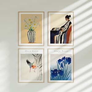 May include: Four framed prints featuring Japanese art. The top left print shows a vase of white flowers. The top right print shows a woman in a striped dress. The bottom left print shows a bird in flight. The bottom right print shows blue irises.
