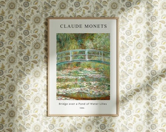 May include: A framed print of Claude Monet's painting "Bridge over a Pond of Water Lilies" from 1886. The painting depicts a green bridge over a pond with water lilies and a blue sky.