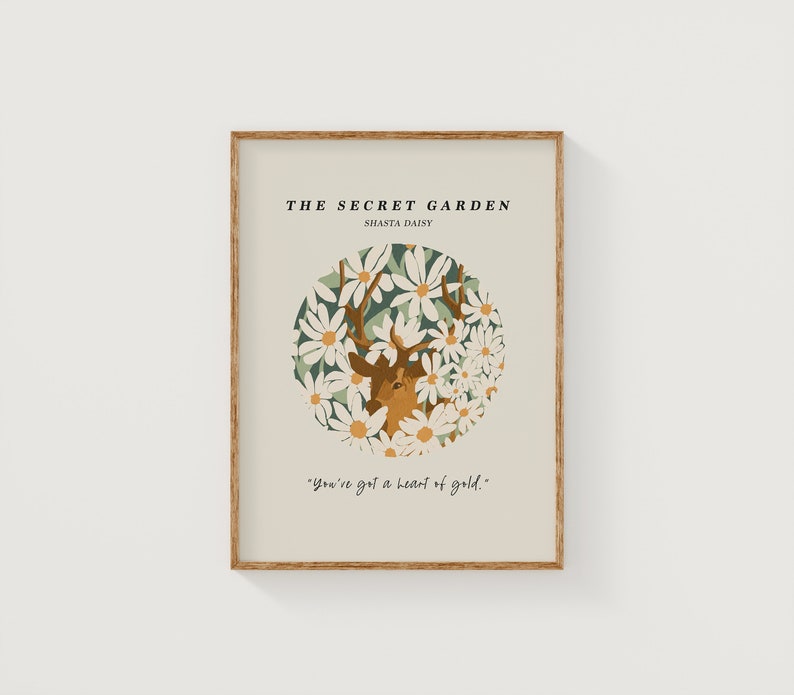 May include: A beige poster with a brown wooden frame features a deer with antlers surrounded by white Shasta daisies. The text "THE SECRET GARDEN" and "SHASTA DAISY" is at the top of the poster. The text "You've got a heart of gold." is at the bottom of the poster.