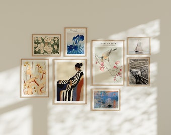 May include: A collection of framed prints featuring various designs, including floral patterns, a woman in a striped dress, a bird on a branch, and a sailboat on water. The prints are arranged on a white wall.