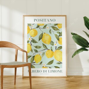 May include: A poster with a watercolor illustration of a lemon tree with lemons and white flowers. The poster has the text "Positano" and "Albero di Limone Costa d'Amalfi" in a teal green font.