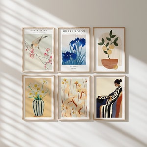 May include: Six framed prints with different floral and abstract designs. The prints are arranged in a grid pattern on a white wall. The prints feature a bird on a branch, iris flowers, a lemon tree, a bouquet of white flowers, a group of figures in a field, and a woman sitting in a chair.