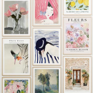 May include: A wall gallery of framed art prints featuring various themes, including floral, nature, and abstract designs. The prints are in a variety of styles and colors, and they are arranged in a grid pattern on the wall.