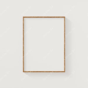 May include: A simple, wooden picture frame with a light brown finish. The frame is empty and ready to display a photo or artwork.
