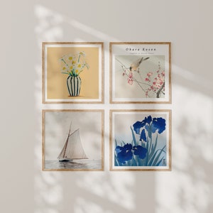 May include: A set of four framed prints featuring Japanese art. The top left print shows a vase with yellow flowers. The top right print shows a bird perched on a branch with pink blossoms. The bottom left print shows a sailboat on the water. The bottom right print shows blue irises.