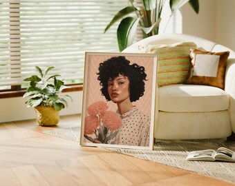May include: A framed print of a woman with curly dark hair holding a bouquet of pink flowers. The background is a pink and white chevron pattern.