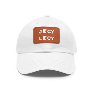 May include: White baseball cap with a brown leather patch featuring the outline of the state of Minnesota and the text "JLCY" in white.