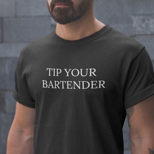May include: A black t-shirt with white text that reads "Tip Your Bartender".