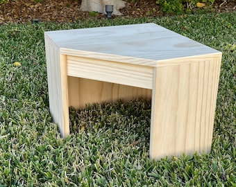 May include: A light wood corner shelf with a simple design. The shelf is made of unfinished wood and has a natural wood grain.