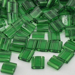 May include: A set of three ceramic mugs with a speckled, matte finish. The mugs are in shades of cream, light gray, and dark gray. Each mug has a simple, minimalist design and a rounded handle. The mugs are suitable for coffee, tea, or other beverages.