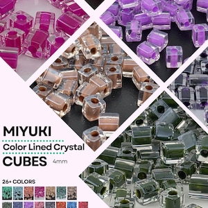 May include: Miyuki Color Lined Crystal 4mm cube beads in various colors including magenta, purple, beige, and dark green. Each bead features a clear outer layer with a solid colored core and a center hole. Text reads MIYUKI Color Lined Crystal CUBES 4mm.